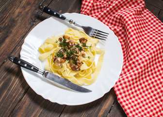 pasta with mushrooms sauce on rustic wood table