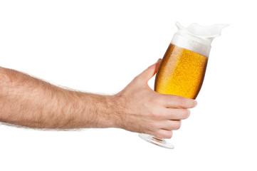 hand with glass of splashing beer