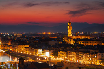 Fototapeta na wymiar Beautiful view of Palazzo Vecchio in evening illumination and the river Arno, Florence, Italy