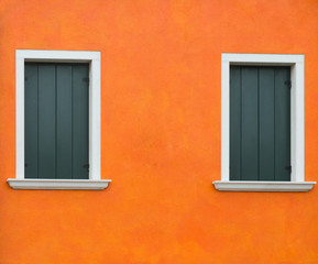 Fototapeta premium Orange old wall with two windows, Burano