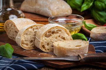 Sliced ciabatta bread on cutting board.