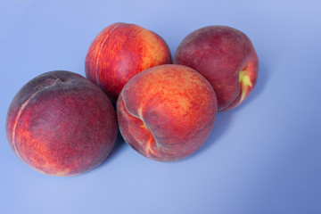 Peaches on a blue background. Empty space for text.