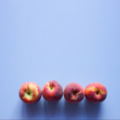 Peaches on a blue background. Empty space for text.