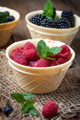 Blackberries, raspberries and blueberries in a waffle bowls.