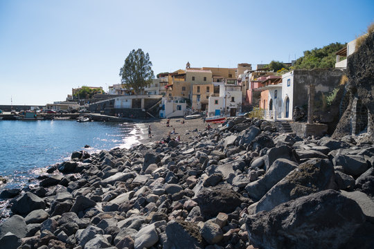 Small village Rinella with beach and many rocks