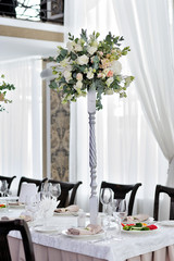 The beautiful decoration of the festive table for guests with flowers