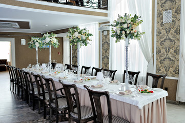 The beautiful decoration of the festive table for guests with flowers
