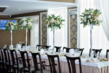 The beautiful decoration of the festive table for guests with flowers