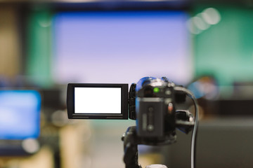 The video camera is recording the lecture in the conference room in selective focus.