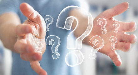 Businessman holding hand drawn question marks