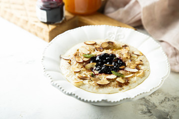 Oatmeal porridge with jam, honey and nuts