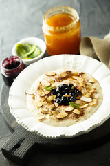 Oatmeal porridge with jam, honey and nuts