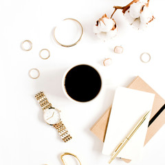 Fashion blog gold style desk with woman accessory collection: golden watches, scissors, coffee cup, notebook and cotton branch on white background. Flat lay. Top view.
