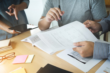 Education, teaching, learning, technology and people concept. Group of high school students or classmates with helps friend catching up workbook learning in classroom, Tutor books with friends