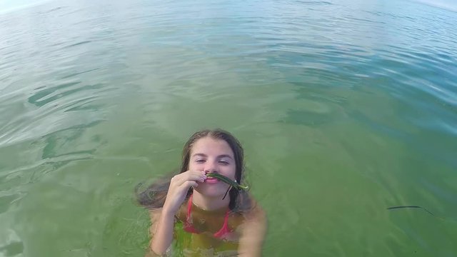 Teenage Girl Makes A Seaweed Mustache, Poses For Gopro, Her Mustache Falls Off And She Laughs