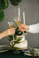 Date of couple, clink with wine glasses on wedding banquet