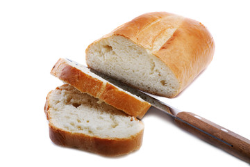 sliced white bread with a knife on a white background