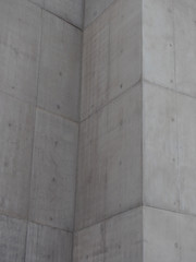 grey concrete walls with block markings and angled corners
