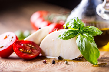 Basil leaves tomato mozzarella and olive oil. Ingredients on italian salad caprese. - obrazy, fototapety, plakaty