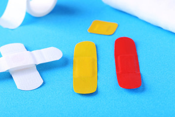 Medical plasters on mint background