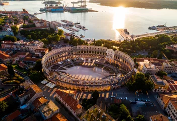 Schilderijen op glas Pula Arena at sunset - HDR aerial view taken by a professional drone. The Roman Amphitheater of Pula, Croatia © concept w