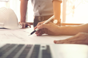 Image of engineer or architectural project, Close up of hands architects engineering working on blueprint with engineering equipment tool, Construction concept