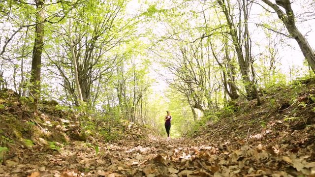 Woman athlete running in the forest. Slide slider