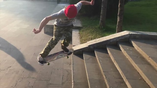Skateboarder does trick from the steps. Slow motion