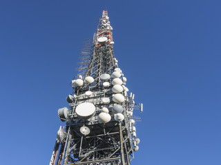 Group of towers for telecommunications on the top of the mountain. Electromagnetic and...
