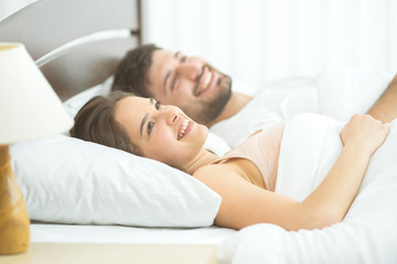 Fototapeta na wymiar The happy couple sleeping in the comfortable bed
