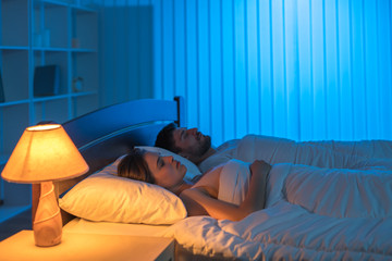 The man and woman sleeping in the bedroom. night time
