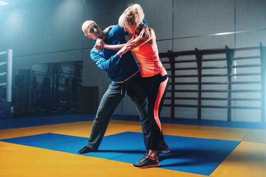 Woman fights with man on self-defense training