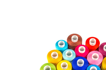 White background of group color threads spools isolated.