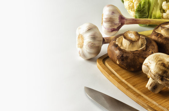 Mushrooms and garlic on a cutting Board