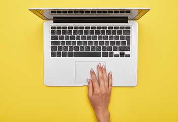 Female hand using touchpad of laptop - obrazy, fototapety, plakaty