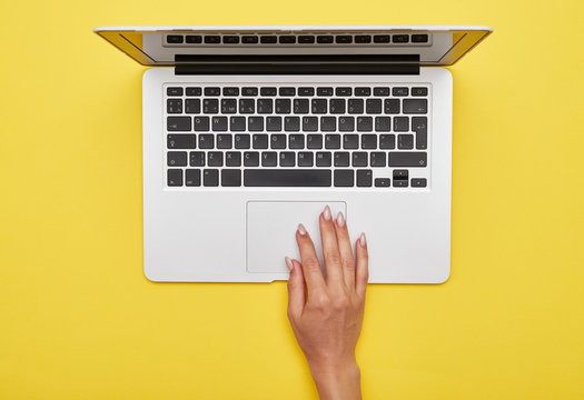 Female Hand Using Touchpad Of Laptop