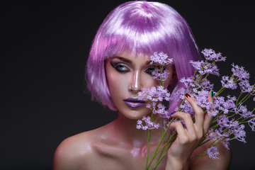 Beautiful girl in purple wig with flowers