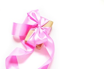 Flat lay holiday background/ Gift box with pink ribbon and bow. Close-up photography