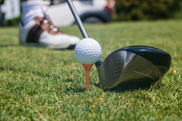 Golfer Hitting Golf Ball off Tee
