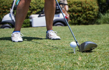 Golfer Hitting Golf Ball off Tee
