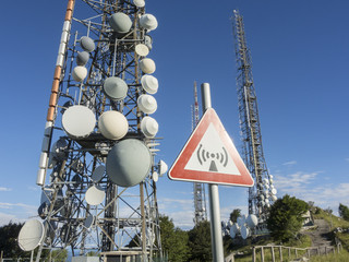 Group of towers for telecommunications on the top of the mountain. Electromagnetic and...