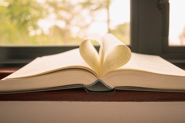 Open book with pages shaped like heart