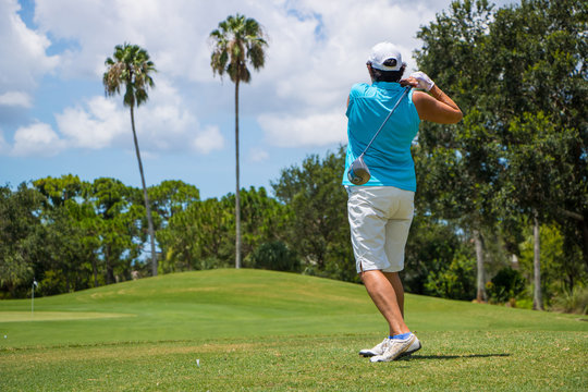 Golfer Hitting Ball on Beautiful Golf Course
