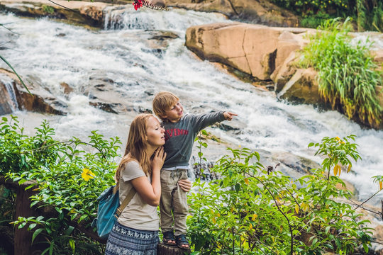 Mother and son on the background of Beautiful Camly waterfall In Da Lat city