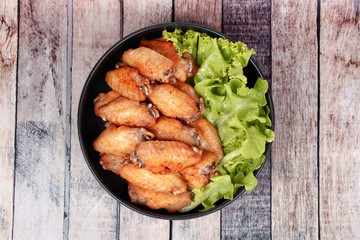 Deep fried chicken wings topped green oak.