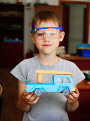 A boy makes a car model