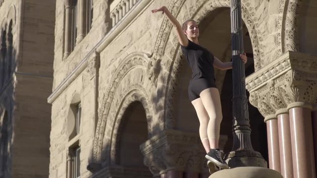 Beautiful Ballet Dancer Holds Onto Lamp Post And Poses With Leg In The Air (Slow Motion)