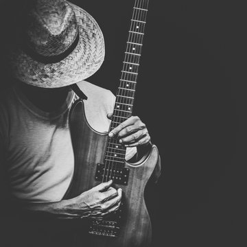 male artist playing electric guitar, black and white