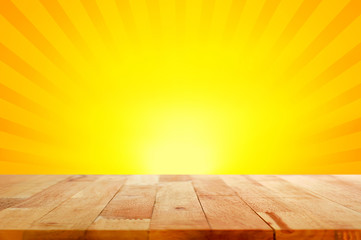 Naklejka na ściany i meble Wood table top on yellow and orange radiate (sunburst) background