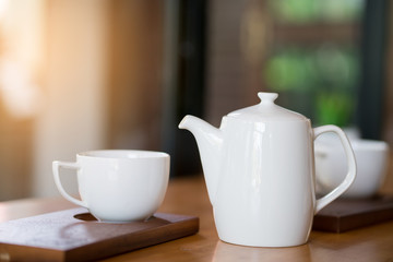 white coffee cup and tea jar